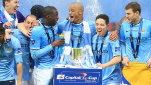 Manchester City players celebrate with the Capital One Cup last season