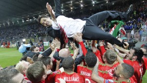 The Wales players celebrate victory with boss Chris Coleman